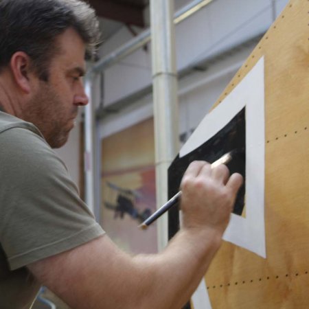 Paul Painting Iron Cross On Vertical Stabilzer